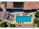 Overhead shot of a backyard showcasing pool with a baja shelf, spa, outdoor seating, and desert landscaping at 42037 N Bradon Way, Phoenix, AZ 85086