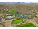 The aerial view features a clubhouse, golf course, tennis courts, swimming pool and desert landscaping at 42037 N Bradon Way, Phoenix, AZ 85086