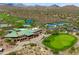 The aerial view features a clubhouse, golf course, tennis courts, and surrounding desert landscape at 42037 N Bradon Way, Phoenix, AZ 85086