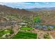 The aerial view features a clubhouse, golf course, tennis courts, and desert landscape at 42037 N Bradon Way, Phoenix, AZ 85086