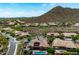 Overhead view of a home with a pool, solar panels, desert landscaping, and mountain views at 42037 N Bradon Way, Phoenix, AZ 85086