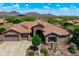 Expansive aerial view of the home showcasing desert landscaping, three-car garage, and mountain views at 42037 N Bradon Way, Phoenix, AZ 85086