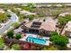 Aerial view of the home showcasing a backyard pool, outdoor seating, and beautiful desert landscaping at 42037 N Bradon Way, Phoenix, AZ 85086