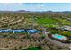 An aerial view of the community's tennis courts, pool, golf course, and surrounding desert landscape at 42037 N Bradon Way, Phoenix, AZ 85086