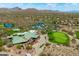 Aerial view showcasing clubhouse with a pool, desert landscaping, and golf course at 42037 N Bradon Way, Phoenix, AZ 85086