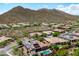 Stunning aerial view of neighborhood homes with solar panels, landscaping, mountain views, and a desert landscape at 42037 N Bradon Way, Phoenix, AZ 85086