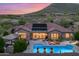 Aerial view of the home featuring a beautiful backyard pool with an outdoor seating area and mountain views at 42037 N Bradon Way, Phoenix, AZ 85086