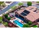 Aerial view featuring a private backyard oasis with a pool, lounge area, and outdoor kitchen at 42037 N Bradon Way, Phoenix, AZ 85086