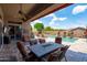 Inviting back patio with a fire pit table and lounge chairs, perfect for outdoor entertaining by the sparkling pool at 42037 N Bradon Way, Phoenix, AZ 85086