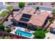 Aerial view of home's backyard oasis with pool, spa, covered patio, lounge chairs and desert landscaping at 42037 N Bradon Way, Phoenix, AZ 85086