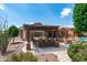 Expansive backyard featuring an outdoor kitchen, pergola, BBQ, lounge seating, and meticulously xeriscaped desert landscaping at 42037 N Bradon Way, Phoenix, AZ 85086