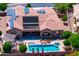 Aerial view of private backyard oasis with pool, spa, patio, lounge chairs, with mountain view at 42037 N Bradon Way, Phoenix, AZ 85086