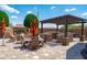 Outdoor space features a fireplace, barbecue, lounge seating and a dining table, creating a cozy and inviting backyard retreat at 42037 N Bradon Way, Phoenix, AZ 85086