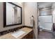 Bathroom showcasing granite counters, decorative backsplash, and a shower with glass door at 42037 N Bradon Way, Phoenix, AZ 85086