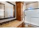 Bathroom featuring granite counters, a shower with glass doors and built in storage at 42037 N Bradon Way, Phoenix, AZ 85086