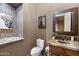Elegant powder room featuring a granite countertop vanity and decorative artwork at 42037 N Bradon Way, Phoenix, AZ 85086