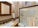 Bathroom vanity featuring granite countertops, and a walk-in shower with a frosted glass door at 42037 N Bradon Way, Phoenix, AZ 85086