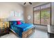Bright bedroom featuring a large window, custom blinds, and plush carpet at 42037 N Bradon Way, Phoenix, AZ 85086