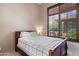 Cozy bedroom with a comfortable bed and lots of natural light from the shuttered windows at 42037 N Bradon Way, Phoenix, AZ 85086