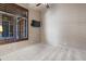 Bright bedroom with neutral carpet, a mounted TV and lots of light from shuttered windows at 42037 N Bradon Way, Phoenix, AZ 85086