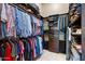 Walk-in closet featuring custom storage for shirts, pants, shoes, and luggage at 42037 N Bradon Way, Phoenix, AZ 85086