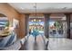 Stylish dining room featuring an elegant chandelier and views of the refreshing outdoor pool at 42037 N Bradon Way, Phoenix, AZ 85086