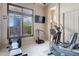 Bright home gym equipped with weight machines, elliptical, and large window at 42037 N Bradon Way, Phoenix, AZ 85086