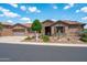 Well-kept single-story home with a three-car garage, stone accents, and desert landscaping at 42037 N Bradon Way, Phoenix, AZ 85086