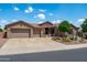 Charming single-story home with a three car garage, stone accents, and well-maintained desert landscaping at 42037 N Bradon Way, Phoenix, AZ 85086