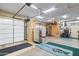 Garage with two large garage doors, storage, work bench and bike at 42037 N Bradon Way, Phoenix, AZ 85086