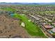 Aerial view of a meticulously designed golf course integrated into a residential area in a desert environment at 42037 N Bradon Way, Phoenix, AZ 85086