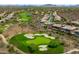 Overhead view showcasing a well-manicured golf course winding through a residential community in a desert landscape at 42037 N Bradon Way, Phoenix, AZ 85086