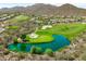 Overhead shot of a picturesque golf course with a water hazard, framed by desert vegetation and luxury residences at 42037 N Bradon Way, Phoenix, AZ 85086