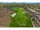 Aerial view of a scenic golf course surrounded by luxury homes and desert landscape with mountain views at 42037 N Bradon Way, Phoenix, AZ 85086