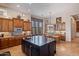 Charming kitchen features custom wood cabinetry, stainless appliances, and an island with seating at 42037 N Bradon Way, Phoenix, AZ 85086