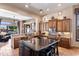 Open-concept kitchen boasts a large island with seating, stainless appliances, and custom wood cabinetry at 42037 N Bradon Way, Phoenix, AZ 85086
