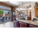 Open-concept living space with kitchen featuring a stone countertop bar with an open view to backyard and pool at 42037 N Bradon Way, Phoenix, AZ 85086