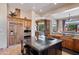 Gourmet kitchen with stainless appliances, custom cabinetry, and an island with bar seating at 42037 N Bradon Way, Phoenix, AZ 85086