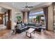 Bright living room with views to the outdoor patio, comfortable seating, and tile flooring at 42037 N Bradon Way, Phoenix, AZ 85086