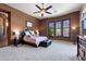 Spacious main bedroom boasts natural light, a ceiling fan, and neutral carpet and paint at 42037 N Bradon Way, Phoenix, AZ 85086