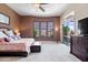 Spacious main bedroom boasts natural light, a ceiling fan, and neutral carpet and paint at 42037 N Bradon Way, Phoenix, AZ 85086