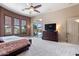 Spacious main bedroom boasts natural light, a ceiling fan, and neutral carpet and paint at 42037 N Bradon Way, Phoenix, AZ 85086