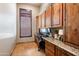 Home office featuring custom wood cabinetry, granite countertops, and ample storage at 42037 N Bradon Way, Phoenix, AZ 85086