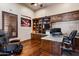 Well-appointed home office with custom wood built-ins, granite countertops, and an executive chair at 42037 N Bradon Way, Phoenix, AZ 85086