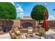 Inviting outdoor stone fireplace with surrounding seating and manicured landscaping, perfect for entertaining at 42037 N Bradon Way, Phoenix, AZ 85086