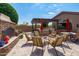 Charming outdoor kitchen and dining area with built-in grill, stone fireplace, and comfortable seating, perfect for entertaining at 42037 N Bradon Way, Phoenix, AZ 85086