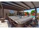 Beautiful outdoor kitchen with bar seating, a grill, and a pergola, overlooking the pool and landscaped backyard at 42037 N Bradon Way, Phoenix, AZ 85086