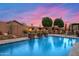 Lush backyard pool with stone fire bowls, waterfalls, and a cozy stone fireplace feature at 42037 N Bradon Way, Phoenix, AZ 85086