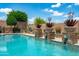 Sparkling pool surrounded by desert landscaping creates a serene backyard oasis for relaxation and outdoor living at 42037 N Bradon Way, Phoenix, AZ 85086