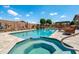 Stunning backyard pool and spa surrounded by mature desert landscaping, outdoor seating, and entertainment area at 42037 N Bradon Way, Phoenix, AZ 85086